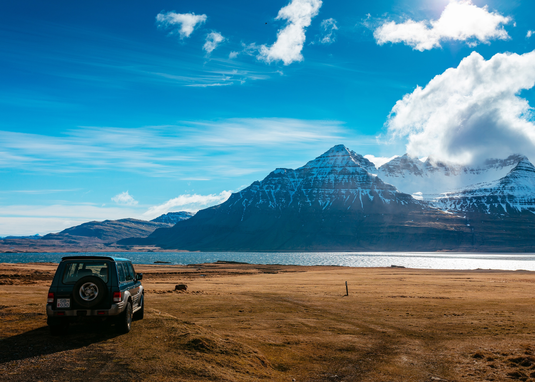 wagon parked in a mountain landscape with blue skies