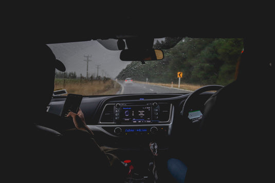 Inside of ute showing dash looking out onto road from the rearseat 