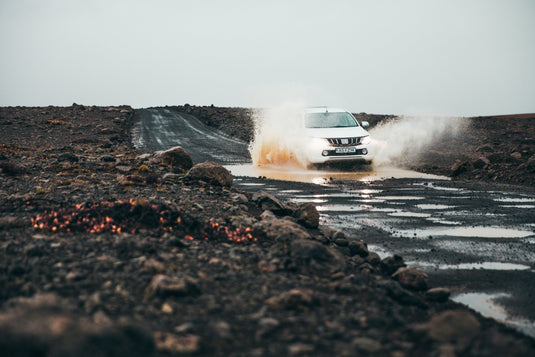 mitsubishi ute, splashing through muddy puddle, on 4wd track