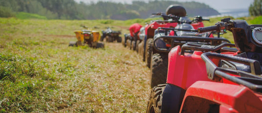 Line up of quad bikes on a sunny nz farm