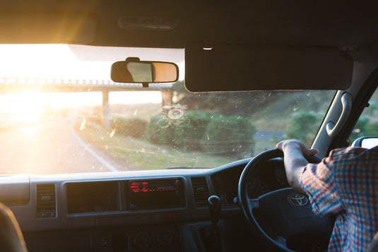 toyota truck driving on motorway, light streaming at sunset