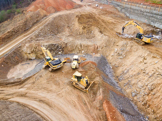 birds eye view of excavators working in a quarry or mine