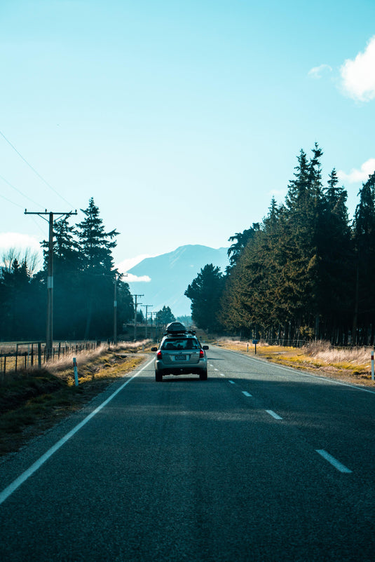 new zealand road, following a subaru, on a clear winters day