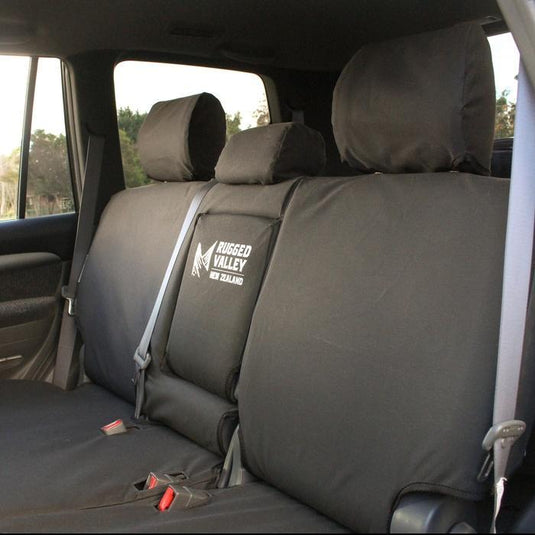 Black Rugged Valley seat covers fitted to rear seat in Wagon, armrest folded up