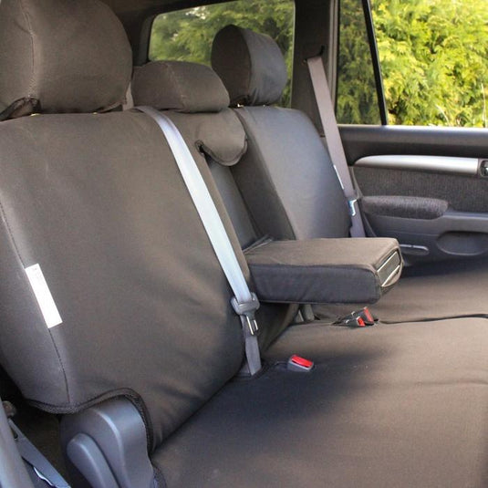 Black Rugged Valley seat cover fitted to rear seats in wagon, armrest folding down